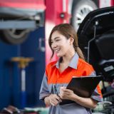 Female employee of customers in car maintenance department. Car center accountant.