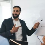 Male and female employees analyzing revenue diagram during collaboration in board room,