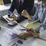 Asia business group meeting and discuss new startup concept projects Business team planning, strategic analysis and brainstorming with office paper reports.