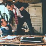 Businessman fighting with his coworker in office.
