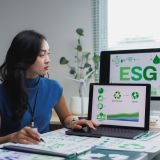 Businesswoman working with esg environmental social and corporate governance diagrams and charts on laptop at office