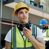 Construction site, architecture and man with radio, communication and building development. Employe.