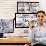 Female security guard with portable transmitter at workplace