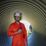 Industry Engineers Walking Inside Circular water Pipe. Engineering or Worker inspection pipe circular. Checking Construction of the water, Oil Natural Gas and fuels Transport Pipeline.