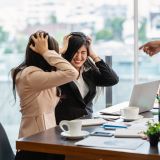Scene of Furious boss scolding asian young couple businesswoman in formal suit by point to her face in modern office, Business mistake and punish concept