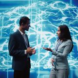 Computer scientists use AI neural networks modeled after human brain to solve complex problems. Startup employees using artificial intelligence to look at data and complete tasks, camera B