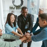 Group of coworkers stacked hands together as concept of corporate unity. High quality photo