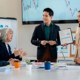 Corporate professionals collaborating in modern workplace, sharing ideas intently
