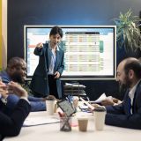 Teammates gathering in a conference room for meetings to go over their input after examining sales representations and feedback from customers. Employee and team leader exchange ideas.