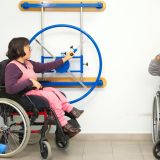 Patients in wheelchairs are actively participating in physical therapy exercises for recovery and inclusion