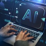 Businessman typing AI on the laptop screen