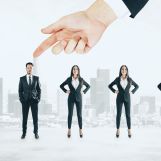 hand-pointing-at-businessman-standing-in-women-row-2026-03-26-05-25-39-utc