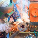 welder-works-on-metal-pipe-in-factory-2026-01-09-00-32-26-utc